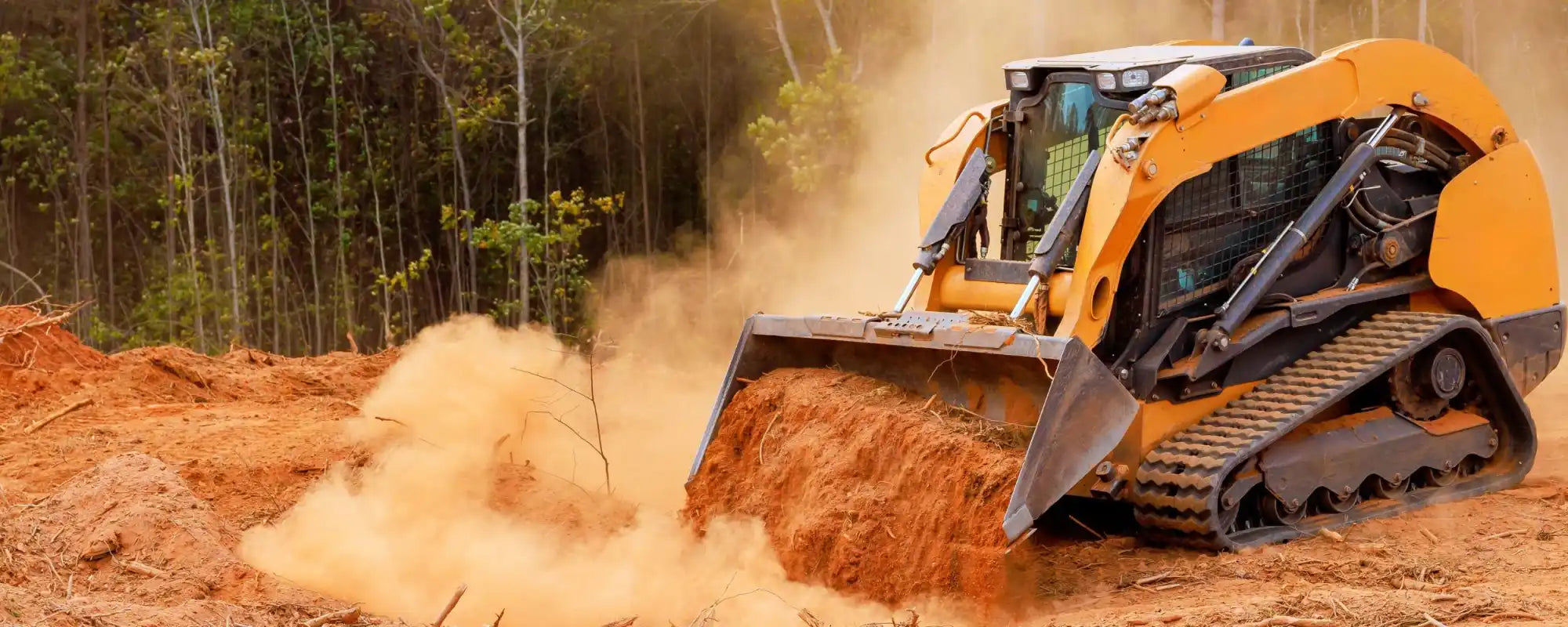 Skid steer loader equipped with Zig-Zag tread heavy-duty rubber tracks for superior traction and durability on construction sites.