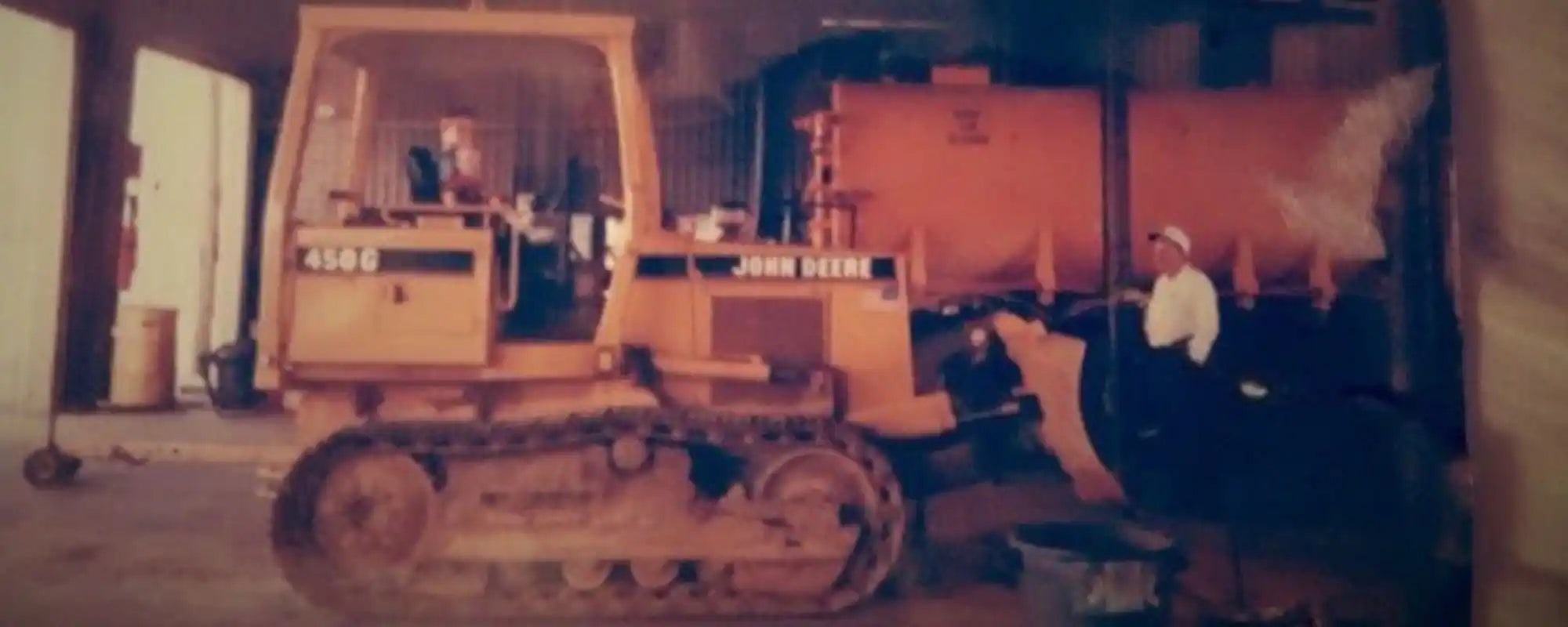 Yellow John Deere bulldozer with a front blade.