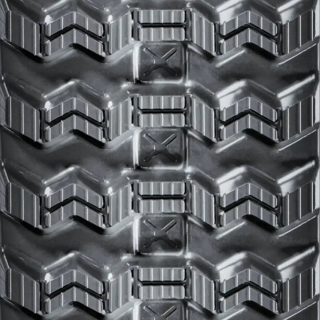 Close-up of zig-zag rubber track tread pattern for skid steer loaders, engineered for reliable all-season traction and improved self-cleaning in mud, clay, and snow.
