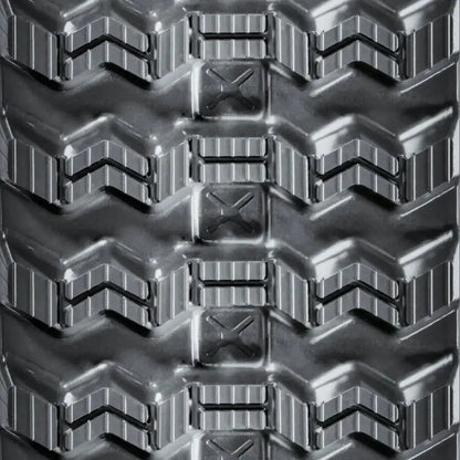 Close-up of zig-zag rubber track tread pattern for skid steer loaders, engineered for reliable all-season traction and improved self-cleaning in mud, clay, and snow.
