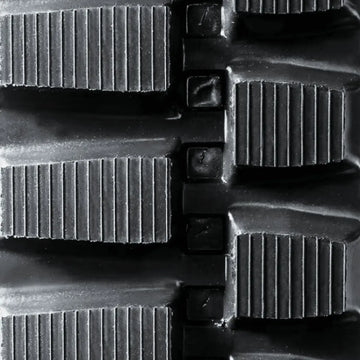Heavy-duty rubber track — tread pattern close-up