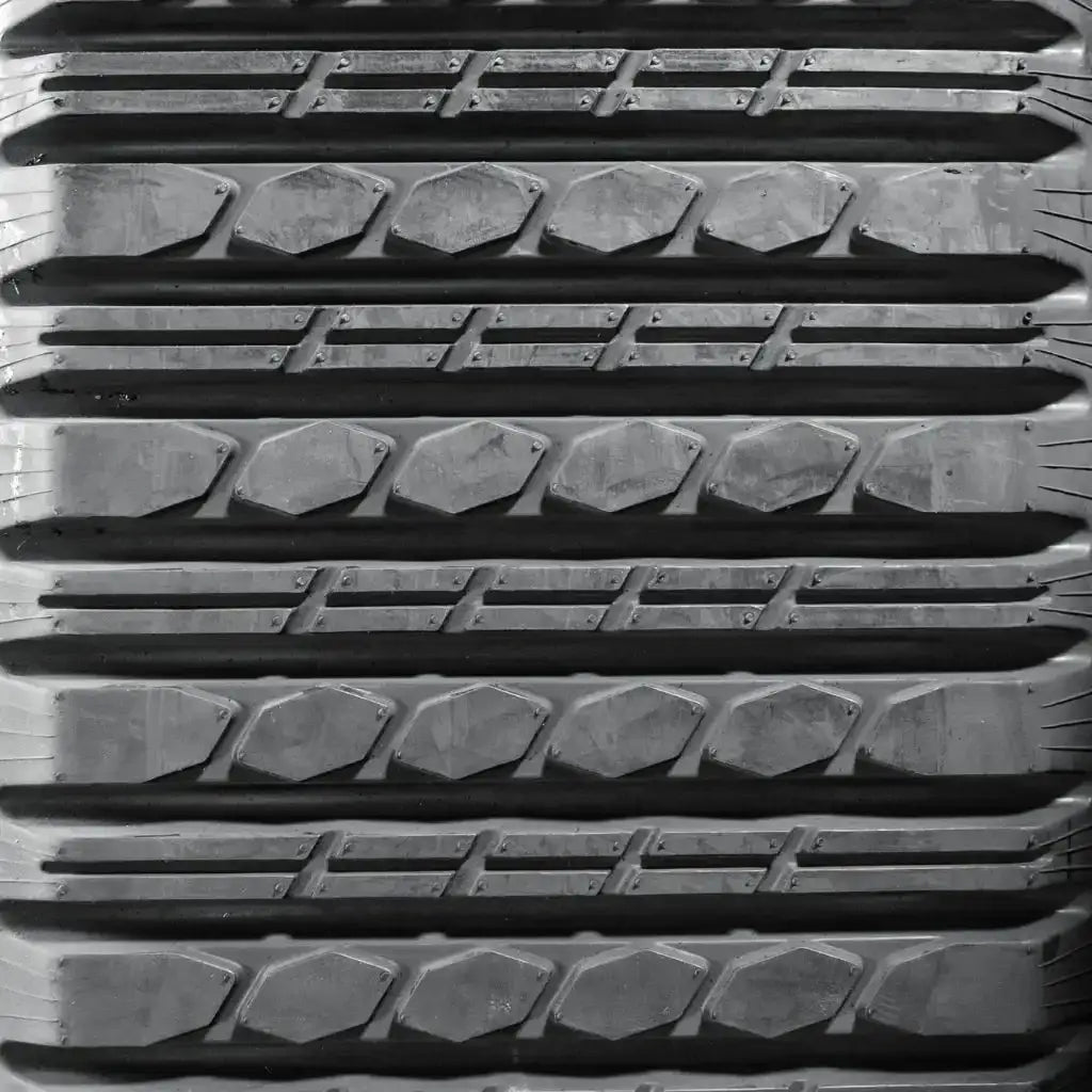 Heavy-duty rubber track with tread pattern for construction equipment or machinery