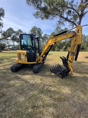 CAT 303.5 CR mini excavator equipped with rubber tracks at a construction jobsite