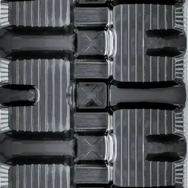 Detailed view of a C-lug tread profile engineered for stability, wear resistance, and smooth operation on compact machinery.