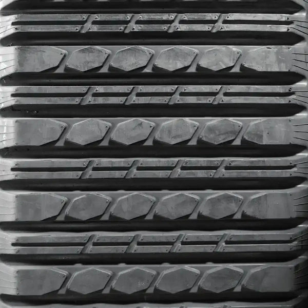 Close-up of multi-bar rubber track tread pattern for compact and multi-terrain track loaders, engineered for low ground disturbance and smoother ride quality on finished surfaces.