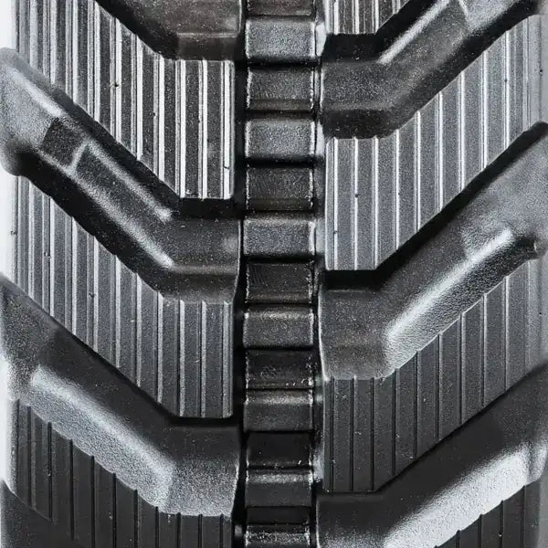 Directional rubber track tread pattern with heavy-duty lugs for mini excavators.