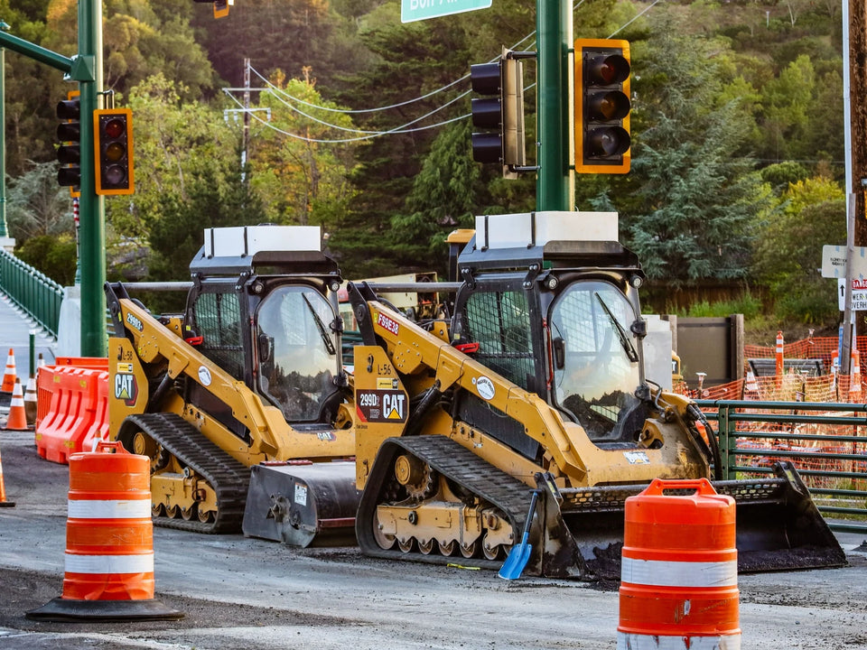 CAT rubber tracks on asphalt paving and grading roadwork — TrackTECH