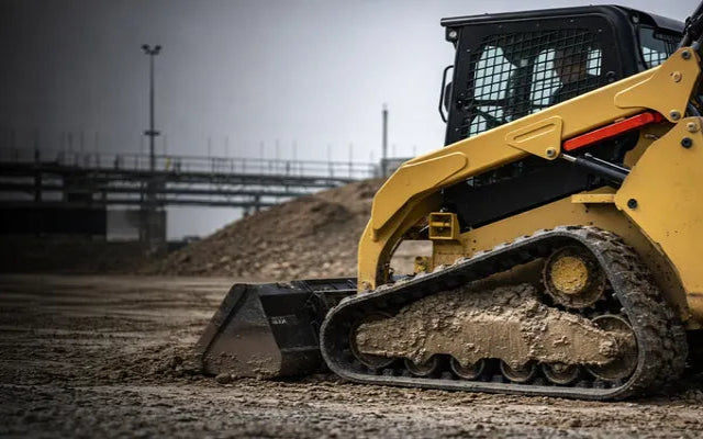 compact track loader equipped with heavy-duty aftermarket tracks – contractor-rated durability – installed view