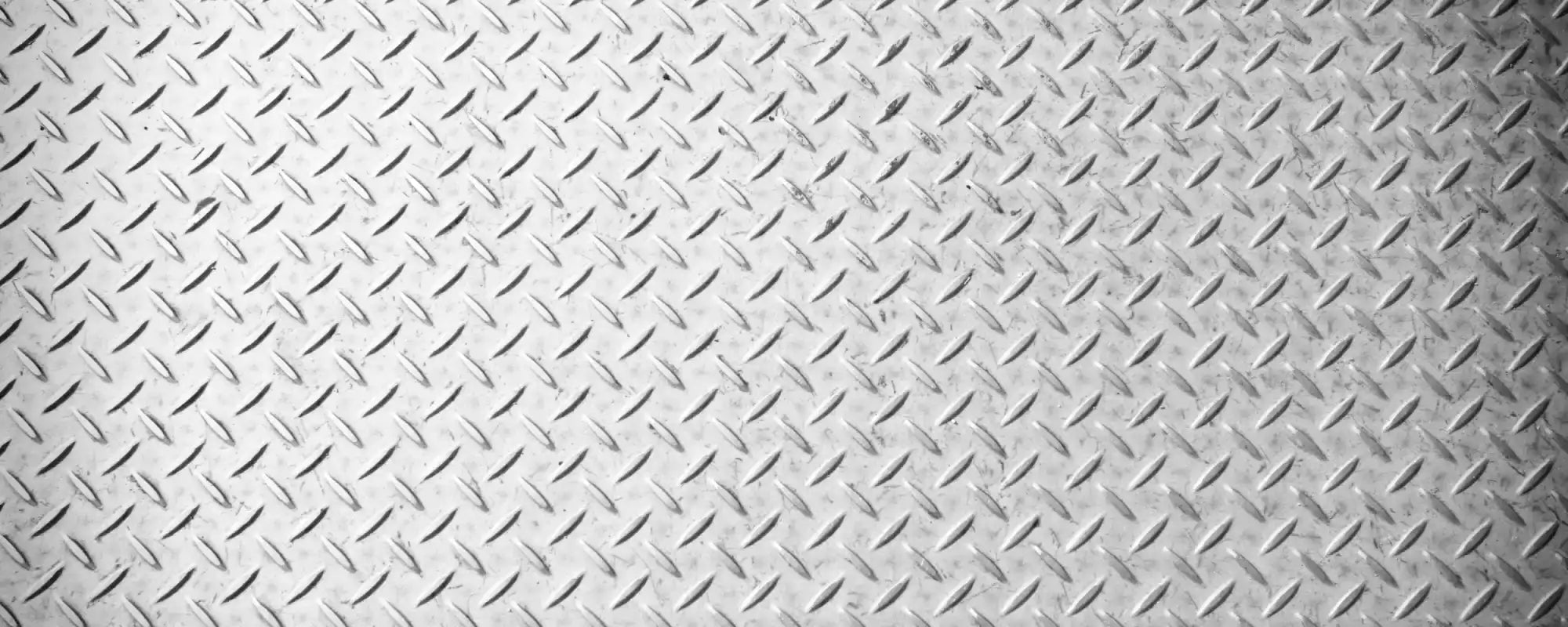 TrackTECH industrial diamond-plate steel background.