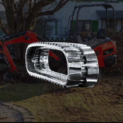 Durable rubber replacement track for a micro excavator and multi-terrain loader, overlaid on a red micro excavator parked on a grassy surface.