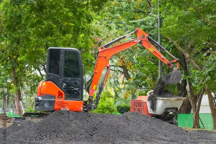 Kubota KX033-4 compact excavator equipped with premium replacement rubber tracks for durability and control.