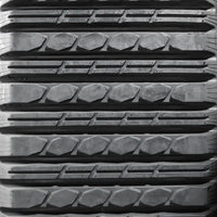 Close-up of Multi-Bar tread pattern – low-vibration rubber track engineered for landscaping and soft ground conditions.