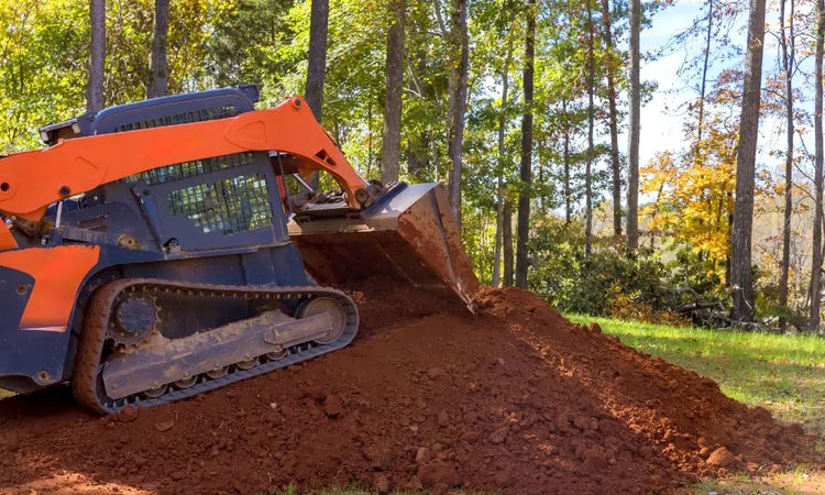 Kubota SVL75-2 compact track loader operating on heavy-duty rubber tracks at a dirt jobsite