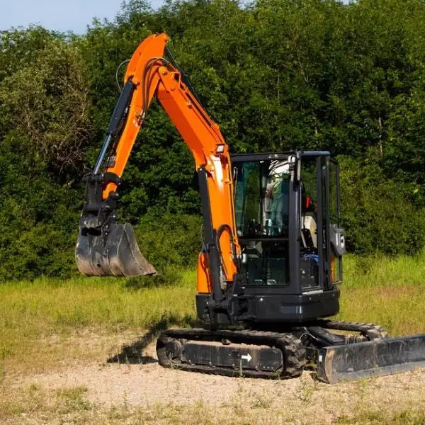 Mini excavator equipped with heavy-duty rubber tracks for stability and traction on uneven ground.