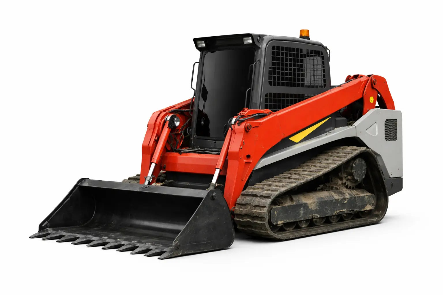 Heavy-duty replacement rubber tracks on a Takeuchi TL12V2 track loader working land-clearing terrain.