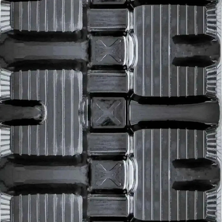 Close-up of heavy-duty rubber track tread pattern and c-lug design