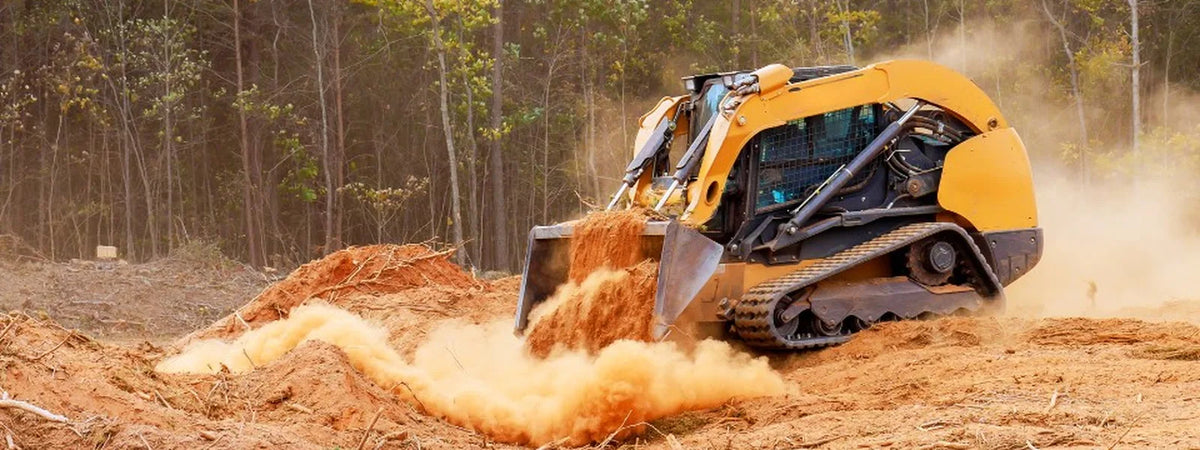Heavy-duty rubber tracks on compact construction equipment