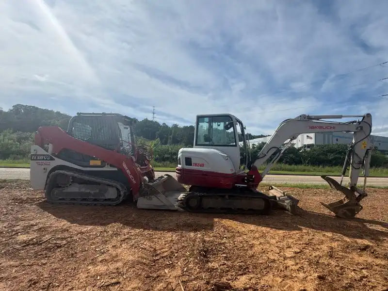 Takeuchi TB240 mini excavator and Takeuchi TL10V2 compact track loader side by side with heavy duty replacement rubber tracks installed