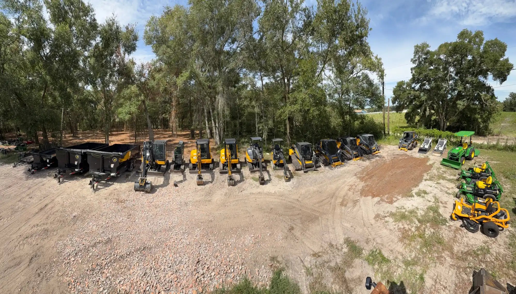 A wide assortment of heavy construction equipment and lawn care machinery.