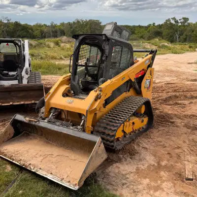 CAT 289D3 skid steer with rubber tracks on dirt jobsite — replacement track install