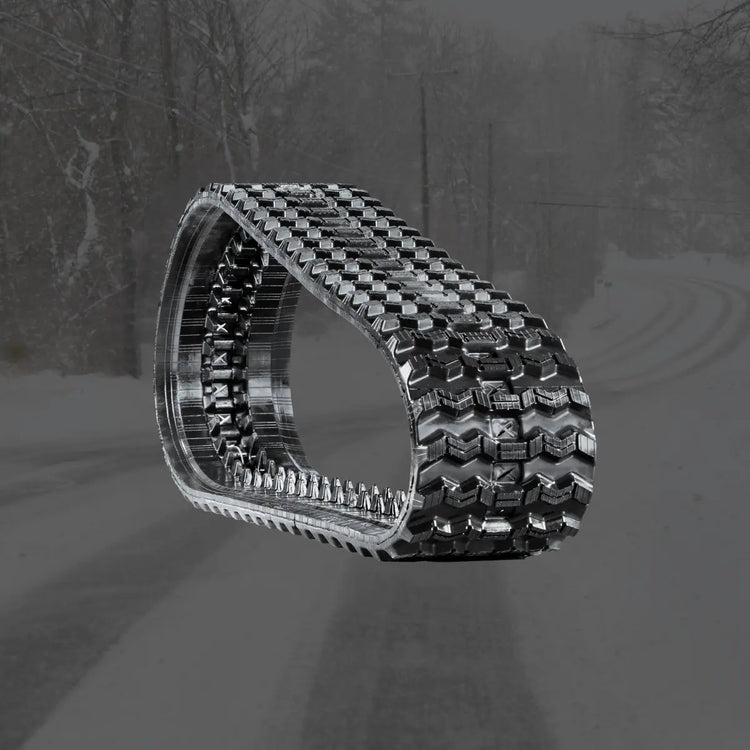 Zig-zag rubber track for compact track loaders in snowy and icy terrain
